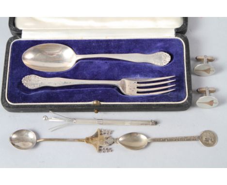 A silver christening spoon and fork set, a silver swizzle stick, a pair of silver Concorde cufflinks, 2.2oz troy approx, and 