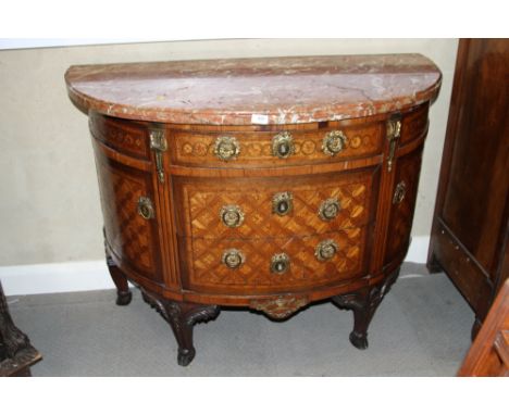An 18th century French mahogany, kingwood, rosewood and satinwood marquetry shape front marble top commode with gilt metal mo