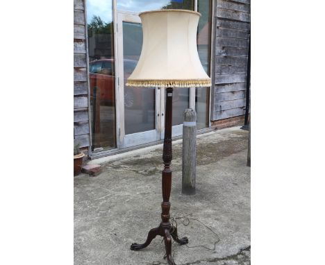 A mid 20th century carved mahogany fluted column standard lamp, on tripod splay support with claw and ball feet, 64" high