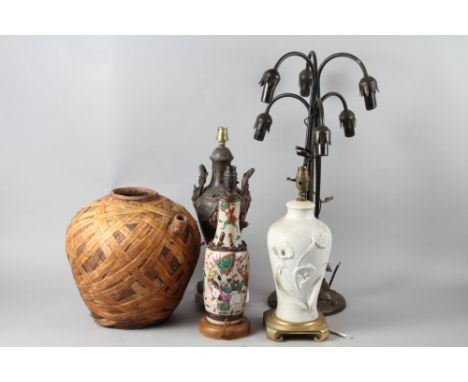An Art Nouveau design six-branch table lamp, a cast iron table lamp of classical form, two others and a vase bound in birch b