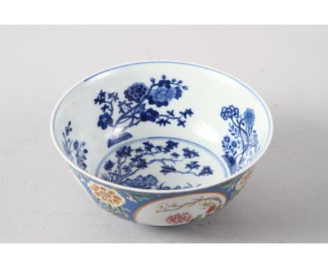 A Chinese famille rose bowl, decorated panels with various flowers on a blue textured glazed ground, seal mark to base, 6" di