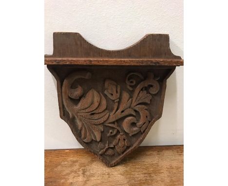 A Carved oak plaque of shelf.