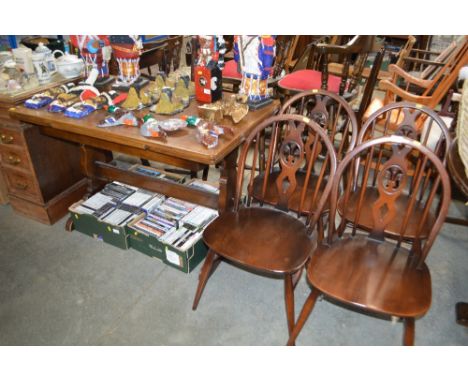 A set of four stick back kitchen chairs and an oak draw leaf table