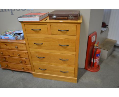 A light oak chest fitted two short over three long drawers