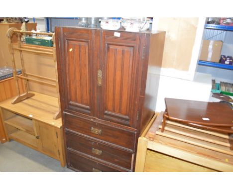 A middle section of a wardrobe, fitted three drawers
