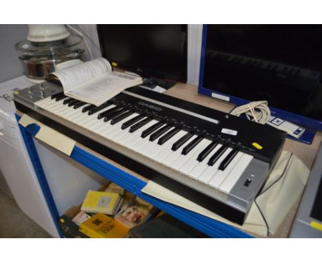 A Casio keyboard with instruction manual