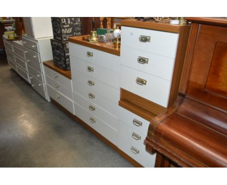 A bedroom suite comprising of a pair of bedside chests fitted three drawers, one other chest fitted six drawers and a three d