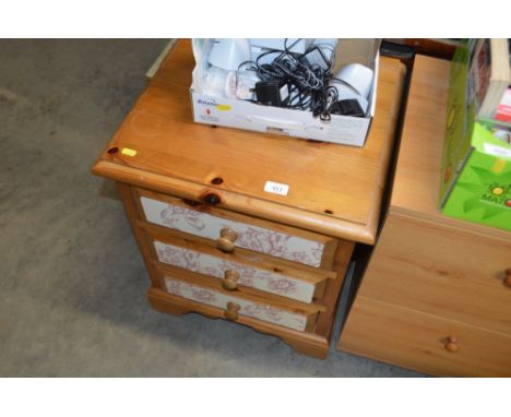 A modern pine bedside chest fitted three drawers