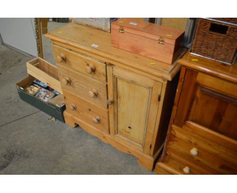 A pine cupboard fitted three drawers