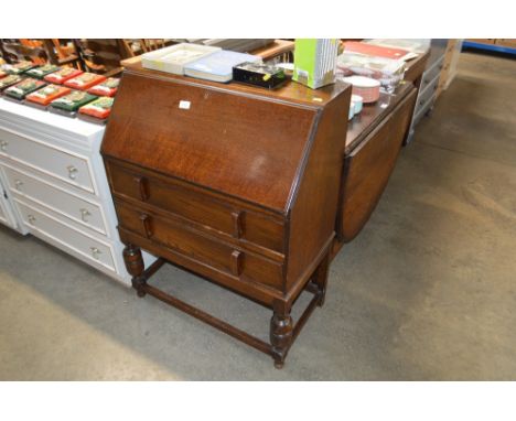 An oak bureau fitted two drawers