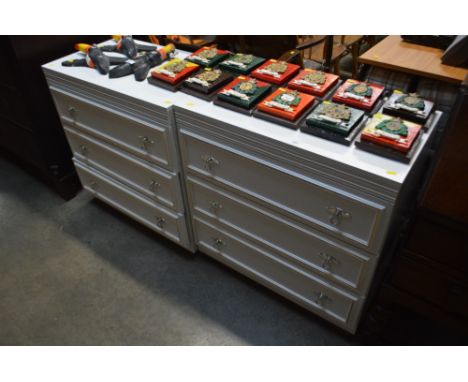 A pair of bedroom chests fitted three drawers