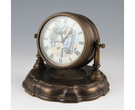 A 20th Century Continental brass bodied clock with the face depicting a Monkey barber with moving arm movement, the chapter r