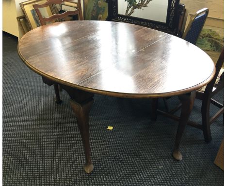 An oak drop leaf gate leg table on cabriole legs.