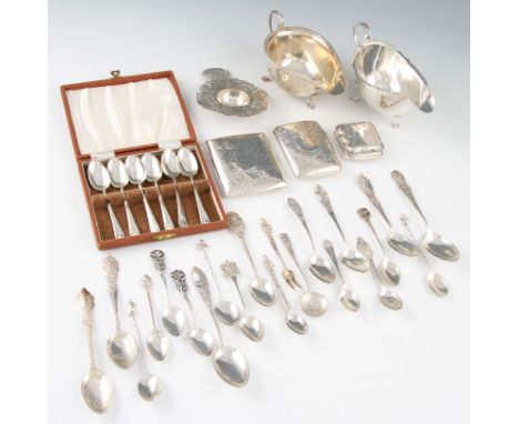 A lot of various silver items to include two sauce boats, two cigarette cases, a boxed set of six shell terminal tea spoons, 