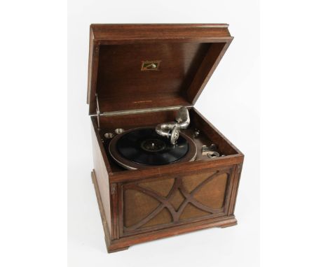An oak cased His Masters Voice gramophone with built in speaker.
