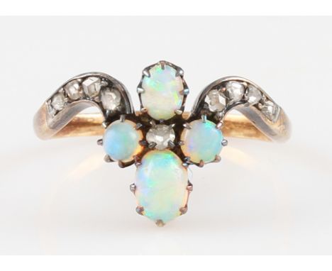 An opal and diamond ring, set with four oval opal cabochons of differing sizes arranged around a round cut diamond, with furt