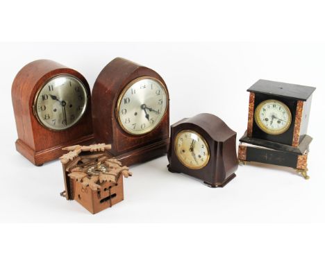 A group of five clocks to include two wooden mantel clocks, slate and marble clock, bakelite clock and cuckoo clock.