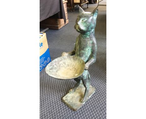 A hollow cast bronze figure of an ancient style standing cat figure holding a dish.