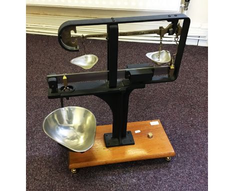 A set of free standing Avery Ltd Birmingham balance scales on wooden stand.