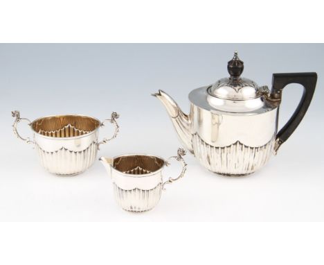 A Victorian three piece bachelor tea set, comprising of a tea pot, sugar bowl and milk jug, all items featuring gadrooned low