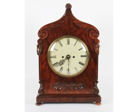 A 19th Century mahogany bracket clock with carved decoration to body with shaped top, the off white dial having black Roman n
