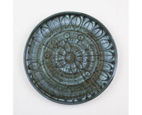 A Troika studio pottery circular plate having stylised leaf and floral design all on blue ground, possibly by Benny Sirota, m