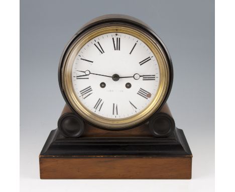 An early 20th Century mahogany cased clock with circular body on stepped base, the white enamel face having black Roman numer