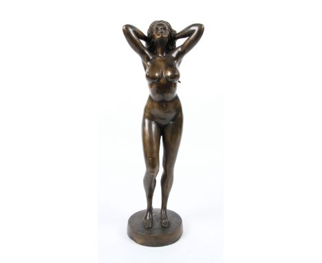 A 20th Century bronze sculpture depicting a standing female nude holding her hair, height 89cm.