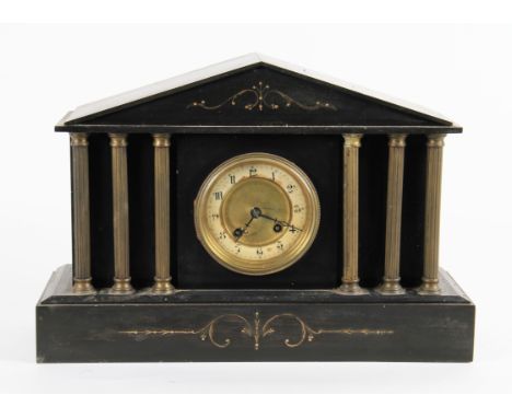 An American style black slate mantel clock with brass column supports with gilt ornate decoration, the chapter ring having bl