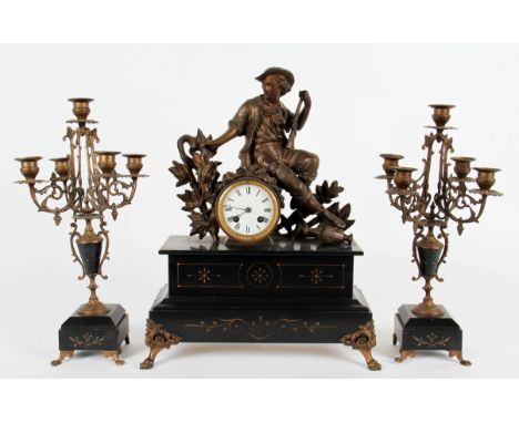 An early 20th Century slate and bronzed clock garniture, the clock having a sculpture depicting seated man in classical dress