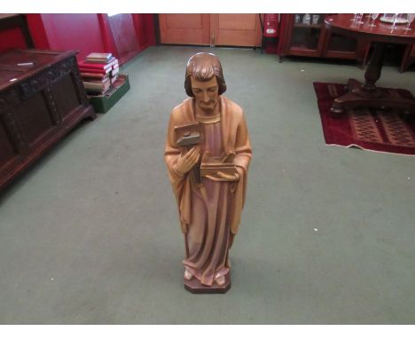 A free standing figure of the religious figure Joseph holding carpenters tools 