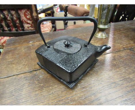 A cast iron Japanese teapot with stand, 21cm long 