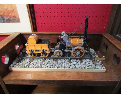 A wood and metal model of Stephenson's Rocket, plinth 41cm length 