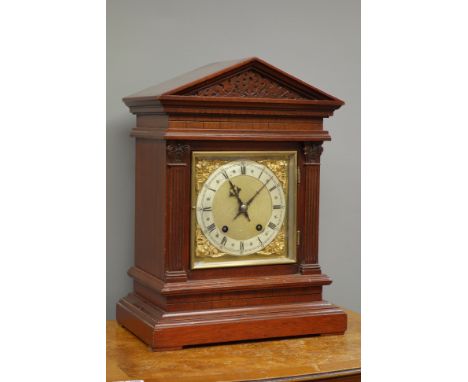 Late 19th century walnut bracket clock, in architectural case with carved frieze, square fluted column pilasters with carved 