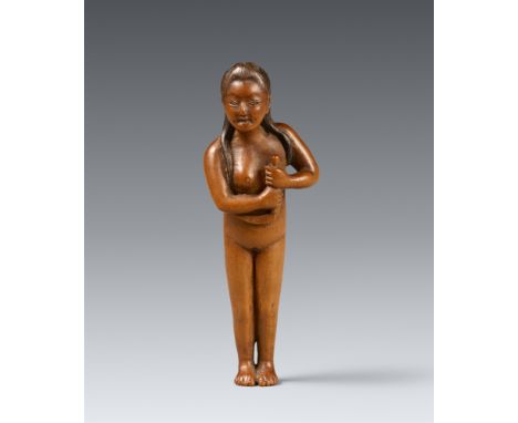 Netsuke einer unbekleidete Perlfischerin (ama). Buchsbaum. 2. Hälfte 19. Jh.Stehend, in beiden Händen ein Messer mit gebogene