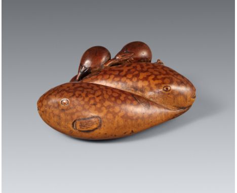Netsuke zweier Kugelfische mit fünf kleinen Auberginen. Buchsbaum. Mitte 19. Jh.Sign. in ukibori: IchirikiZwei Kugelfische vo