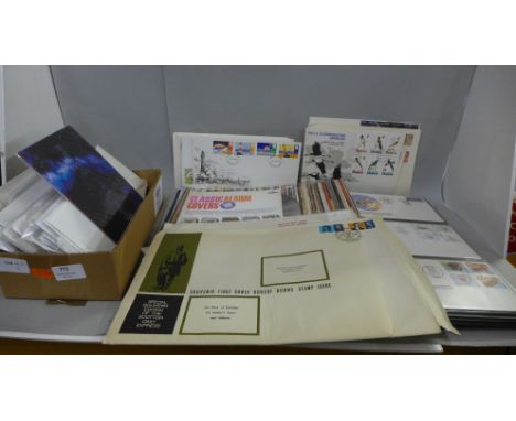 Stamps; a box of world first day covers, loose and in album 