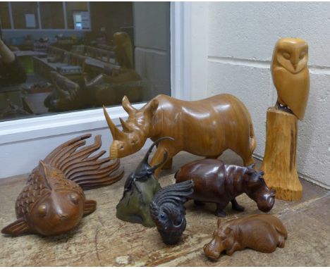 Model wooden animals; owl, hippopotamus, rhinocerous, shubunkin, a carved wooden parrot walking cane handle and a carved resi