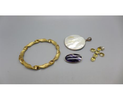 A silver gilt bangle, a silver and yellow stone set cross, a Blue John Brooch and a silver and mother of pearl pendant 