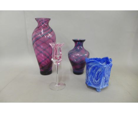 Three items of Caithness glass comprising two amethyst vases and a candlestick and a marbled slag glass jug, (4) 