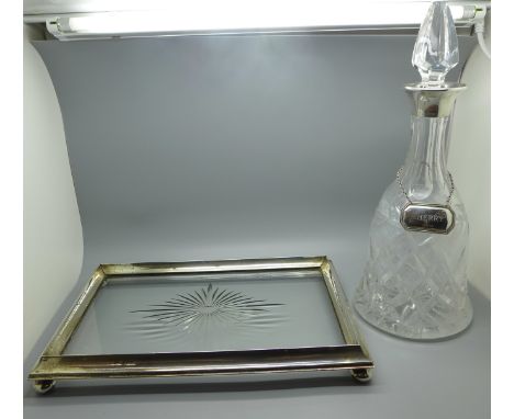 A silver and glass teapot stand and a silver rimmed decanter with silver sherry label 