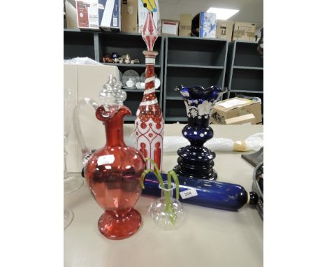 A selection of antique cranberry and similar glass wares including Bristol blue rolling pin, Bohemian overlay and gilt decora