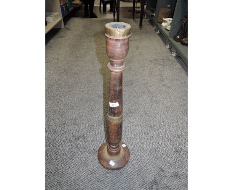 A turned wood and brass Indian temple candlestick.
circa 19th century,25" height.