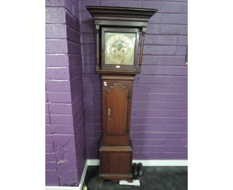 An 18th century oak eight-day long case clock, named Miles Wedred (Kirby Lonsdale), having a moulded flat-topped hood over gl