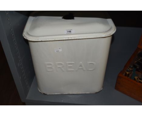 A vintage white enamelled metal bread bin, with cover, some enamel losses, cover lacking handle.