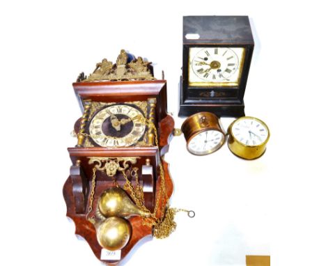 An ebonised alarm timepiece clock together with a Dutch style wall clock and two small brass alarm timepieces including one b