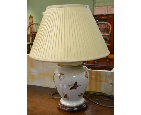 A 20th century decorative pottery table lamp, painted with butterflies and with silk shade 