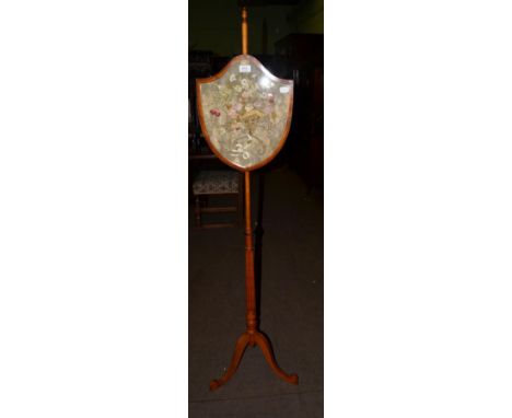 A 19th century satinwood polescreen, with embroidered shield from panel, fluted column and tripod base 