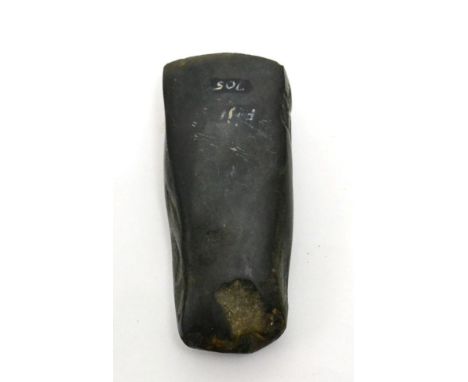 An ancient carved black stone axe or celt, Fiji, circa 500BCE-500 A.D. of polished surface and typical form, 13cm wide, Ex J 