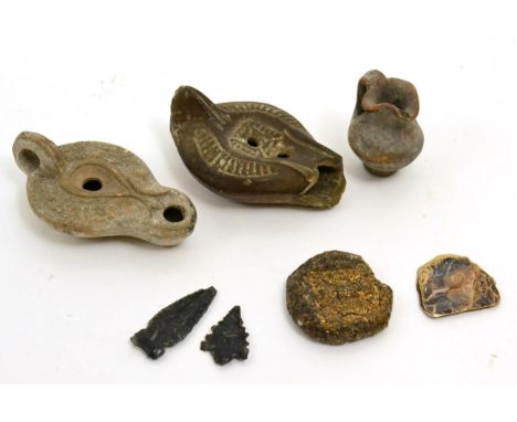 A Roman terracotta oil lamp, circa 200 AD-400 AD, with raised beaded decoration, 11cm wide, a lamp fragment, a Roman terracot